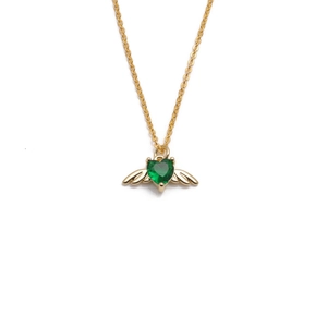 Gold angel wing necklace with heart-shaped emerald green gemstone pendant on white background