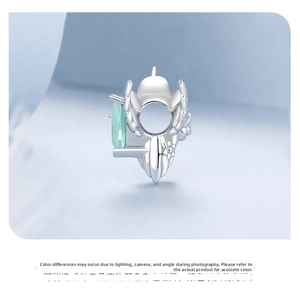 Macro detail of 925 sterling silver charm with light green rectangular zircon stones