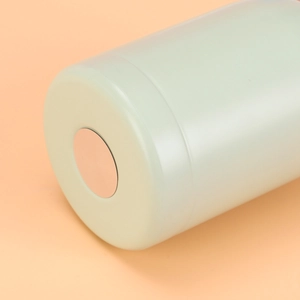 Detail of the light green stainless steel vacuum flask base with polished metal disc
