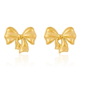 Detailed view of gold ribbon bow earrings with beaded edges and tiny heart center