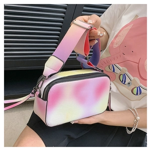 Detail of gradient crossbody bag featuring colorful PU leather and wide shoulder strap