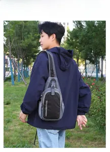Waterproof crossbody sling bag with adjustable strap shown in outdoor park setting