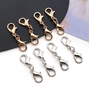 Detailed view of dual lobster claw jewelry connectors in gold and silver finishes