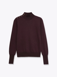 Detail of burgundy mock neck knit top featuring decorative gold buttons on shoulder