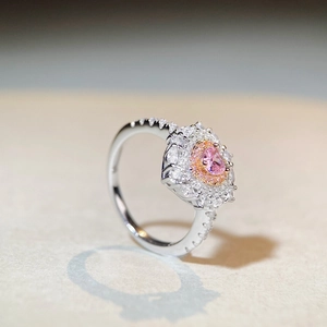 Minimalist S925 silver ring featuring a halo-set pink oval gemstone and side diamonds