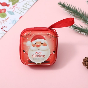 Close-up of a red square tin Christmas coin purse with Santa Claus and hanging strap