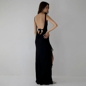 Elegant backless black maxi dress with ruffle detailing and a high slit for summer