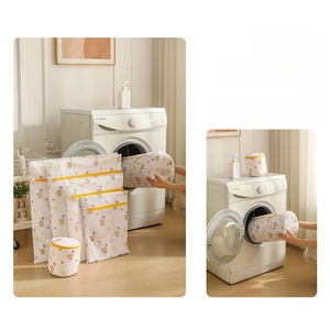 Detail of cartoon bear laundry mesh bags with yellow zippers in various sizes and shapes