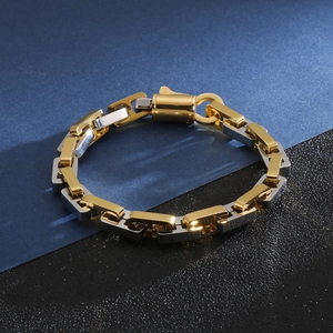 Macro view of gold and silver tone rectangular chain link bracelet with lobster clasp