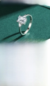 Close-up of S925 silver ring featuring emerald cut cubic zirconia and side stones
