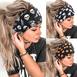 Macro shot of Halloween headbands with pumpkin, skull, and ghost prints on fabric