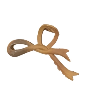 Beige gradient acrylic bow hair claw clip with glossy finish for women's hairstyling