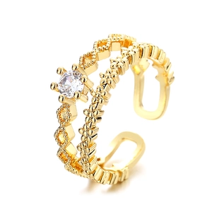 Double-layered gold open ring with geometric patterns and a sparkling round zircon stone