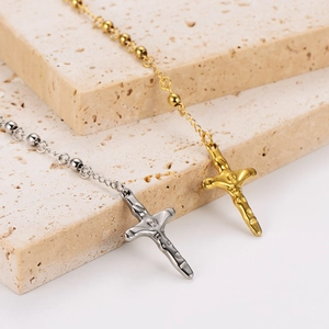 Detail of 18k gold and silver stainless steel bead chains with crucifix pendants