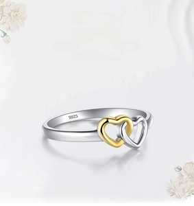 Macro shot of S925 sterling silver ring showing dual interlocking hearts and S925 stamp