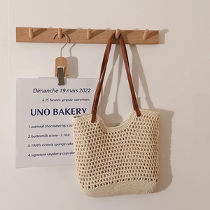 Beige hollow knit shoulder bag with brown PU leather straps for summer beach vacations