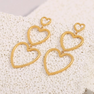 Detail of 18K gold-plated triple heart earrings featuring textured snake skin patterns