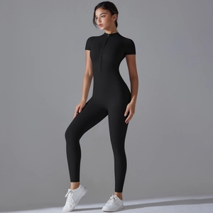 Close-up of sleek black yoga jumpsuit featuring short sleeves and a zipper neckline detail