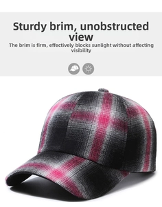 Close-up of the structured brim on this pink, black, and grey plaid baseball cap