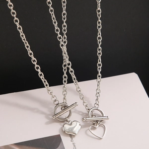Detail view of silver heart pendants with OT toggle clasp and modern chain design