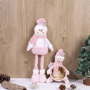 Detail of pink sequined Christmas snowman dolls with knit textures and mini basket decor