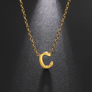 Polished 18k gold plated stainless steel initial C pendant necklace on black background