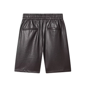 Brown faux leather high waist shorts with elastic waistband and back pockets on white background