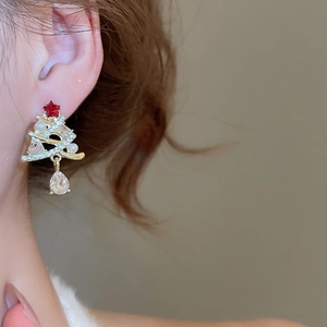 Detail of Christmas tree drop earring with sparkling crystals and a pear-shaped pendant