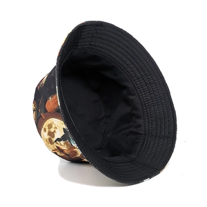 Detailed view of reversible Halloween bucket hat with cartoon moon and bat prints