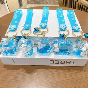 Sky blue liquid quicksand keychain with white rabbit charm and silicone star strap