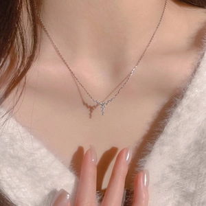 Exquisite silver star necklace with zircon pendant worn on a cozy white sweater