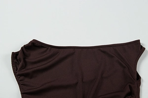 Detail of dark brown ribbed knit fabric with vertical texture and rounded neckline
