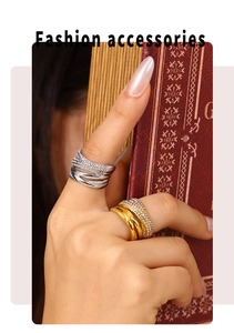 Close-up of gold and silver layered crisscross rings with sparkling pavé cubic zirconia