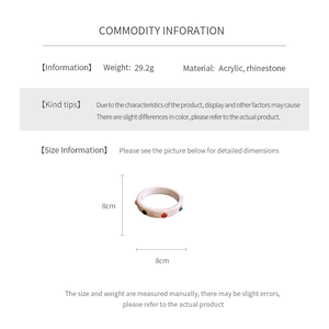 Detailed size and material information for the cream acrylic rhinestone bangle