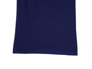 Detailed macro view of the dark blue dress hemline showing fine knit texture and stitching