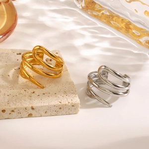 Minimalist geometric spiral ring set in gold and silver finish on textured stone