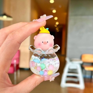 Close-up of pink pig figurine in a liquid sand acrylic bottle for keychain bag charms