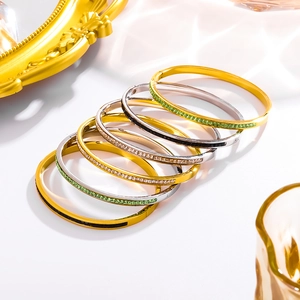 Set of six minimalist gold and silver bangles with colorful zircon inlay and mirror finish