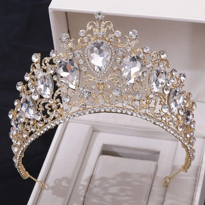 Macro detail of luxury gold bridal crown with brilliant clear crystals in a white gift box