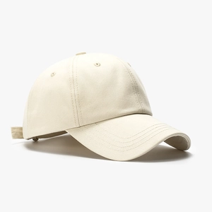 Minimalist beige cotton baseball cap with adjustable strap and breathable vents