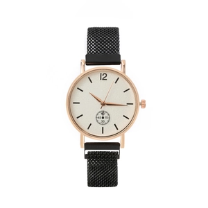 Detail of rose gold women's watch with black mesh strap and minimalist white dial