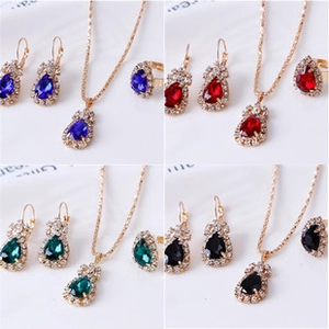 Detailed close-up of leaf jewelry set with pear-cut gemstones and diamond halo accents