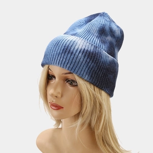 Close-up of blue and white tie-dye knitted beanie showing the soft core-spun yarn texture