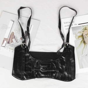 Flat lay of black PU leather corset belt with metal buckles on white background