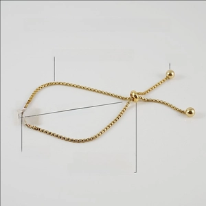 Detail of adjustable pearl chain bracelet with a square shell pendant and letter A engraving