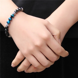 Tiger eye stone bead bracelet with blue and black gems for men and women on wrist