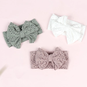 Three-piece baby headband set featuring large bows in sage green, white, and dusty rose colors