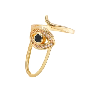Macro detail of gold evil eye nail ring with pave cubic zirconia and black center stone