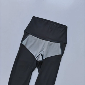 Detail view of high-waisted yoga leggings showing breathable grey inner crotch lining