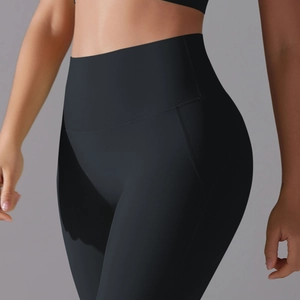 Close-up of high-waist black yoga leggings with butt-lifting seams and elastic fabric